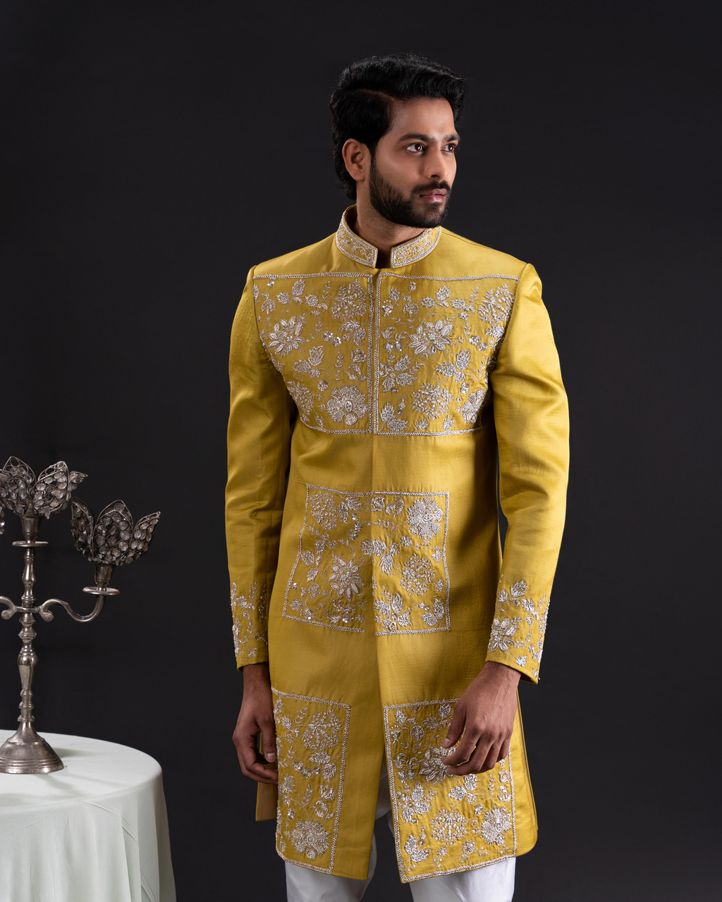 Front shot showing the sherwani silhouette and motif placement.