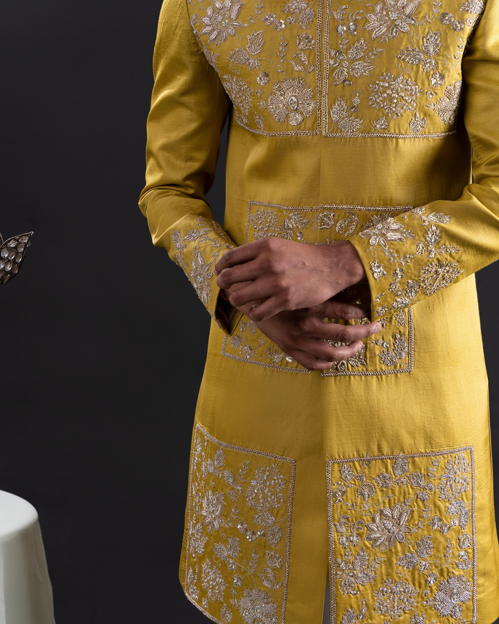 Close-up shot of gold thread embroidery on sherwani