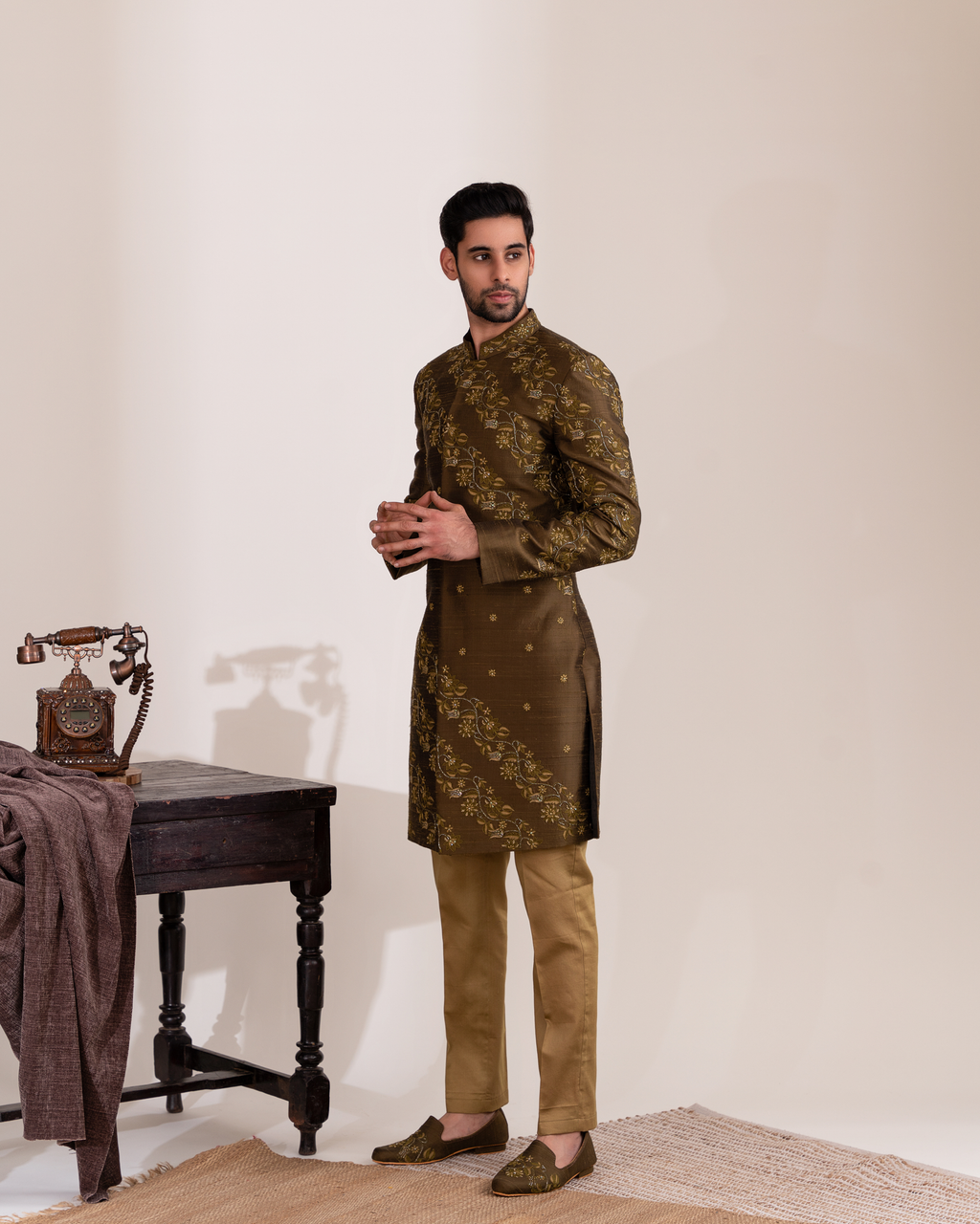 Side profile showing green sherwani structure and embroidered accents