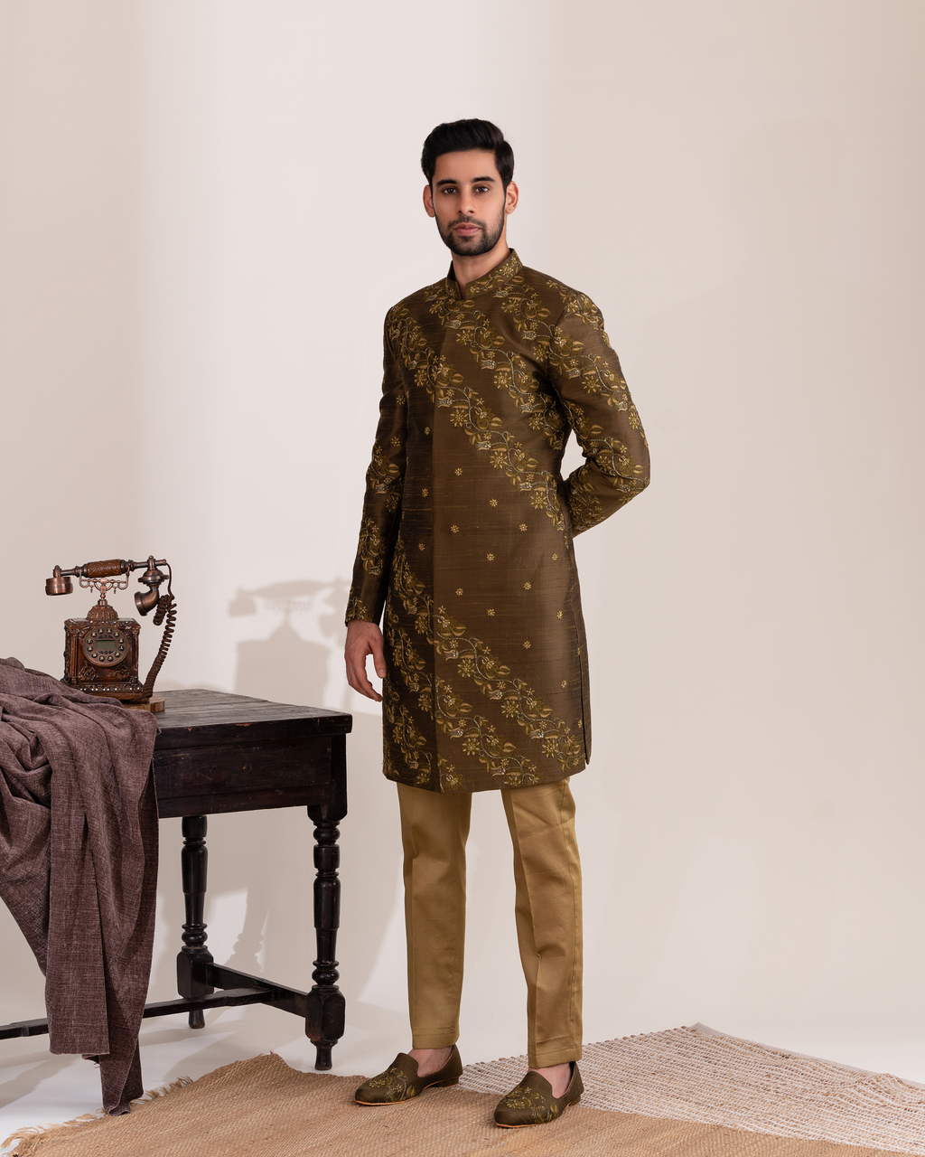 Man wearing a traditional brown kurta with embroidery 