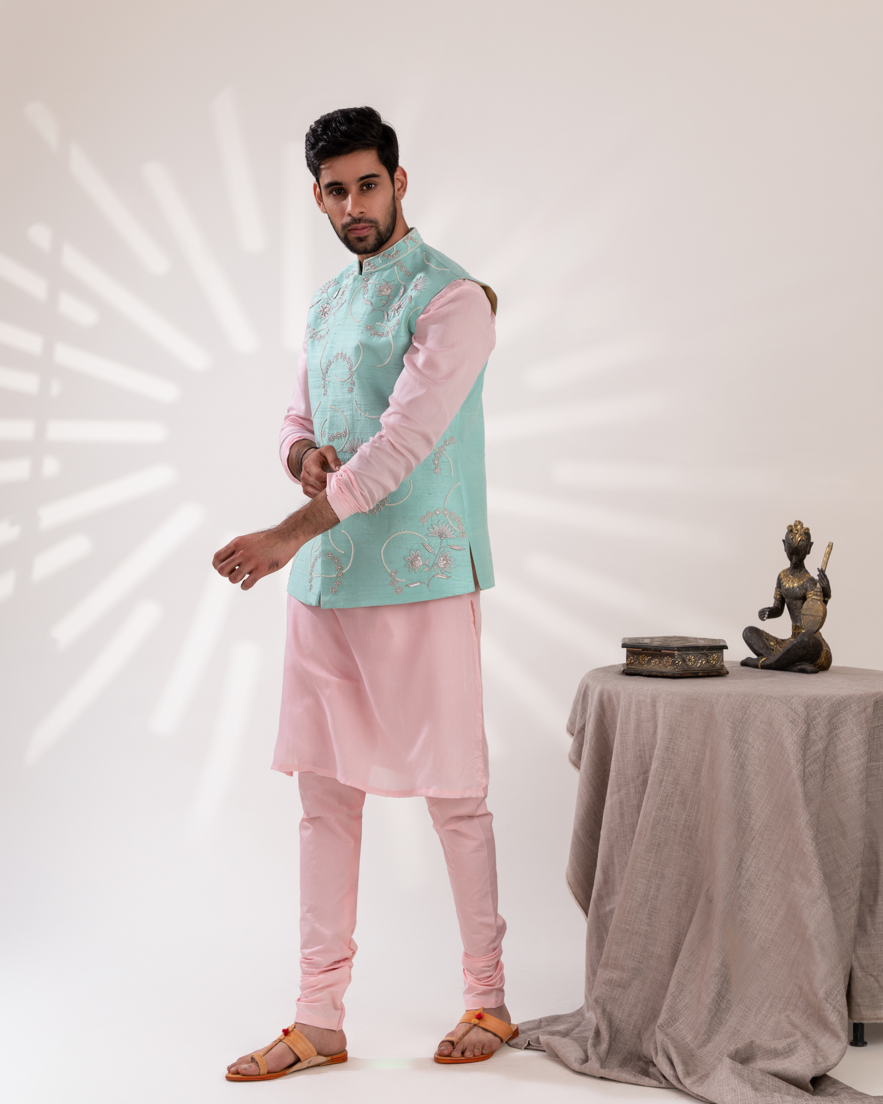 Side profile revealing bundi with kurta and straight fit pants.