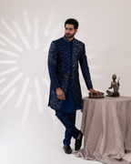 Frontal shot showing structured blue sherwani and straight pants