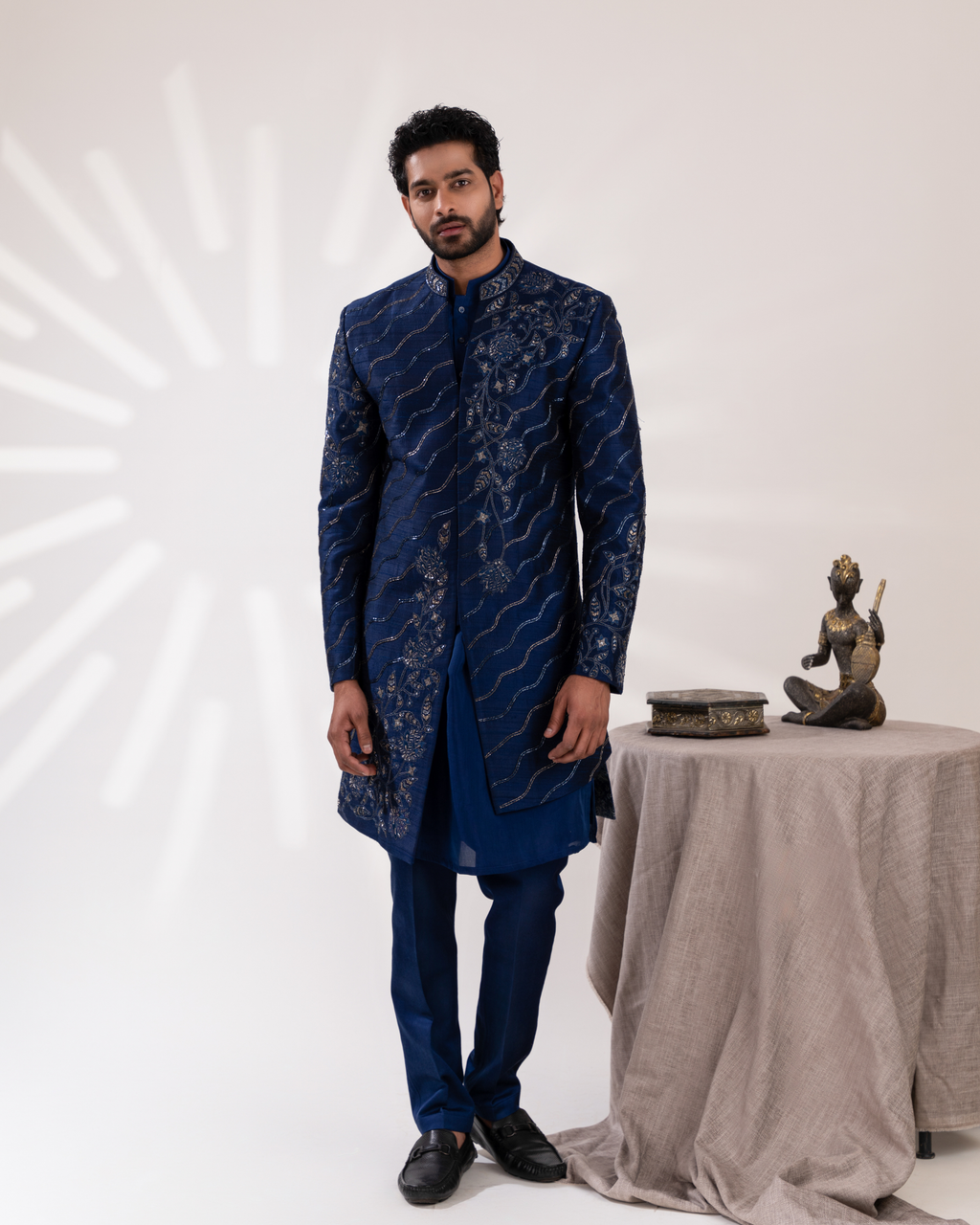 Front angle capturing blue sherwani silhouette and straight pants