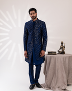 Front angle capturing blue sherwani silhouette and straight pants