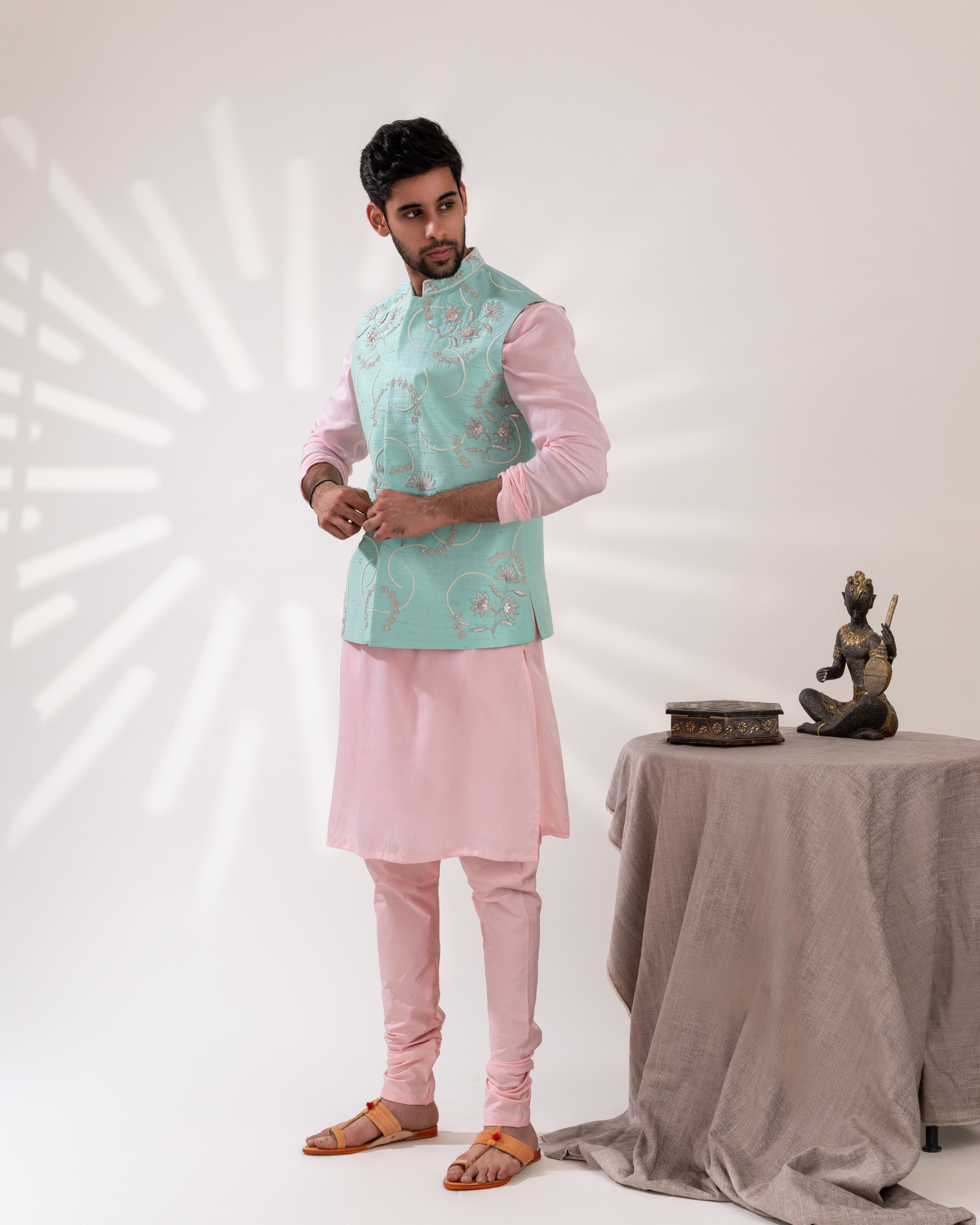 Full front shot showing the fresh aqua tone bundi jacket and kurta fit.