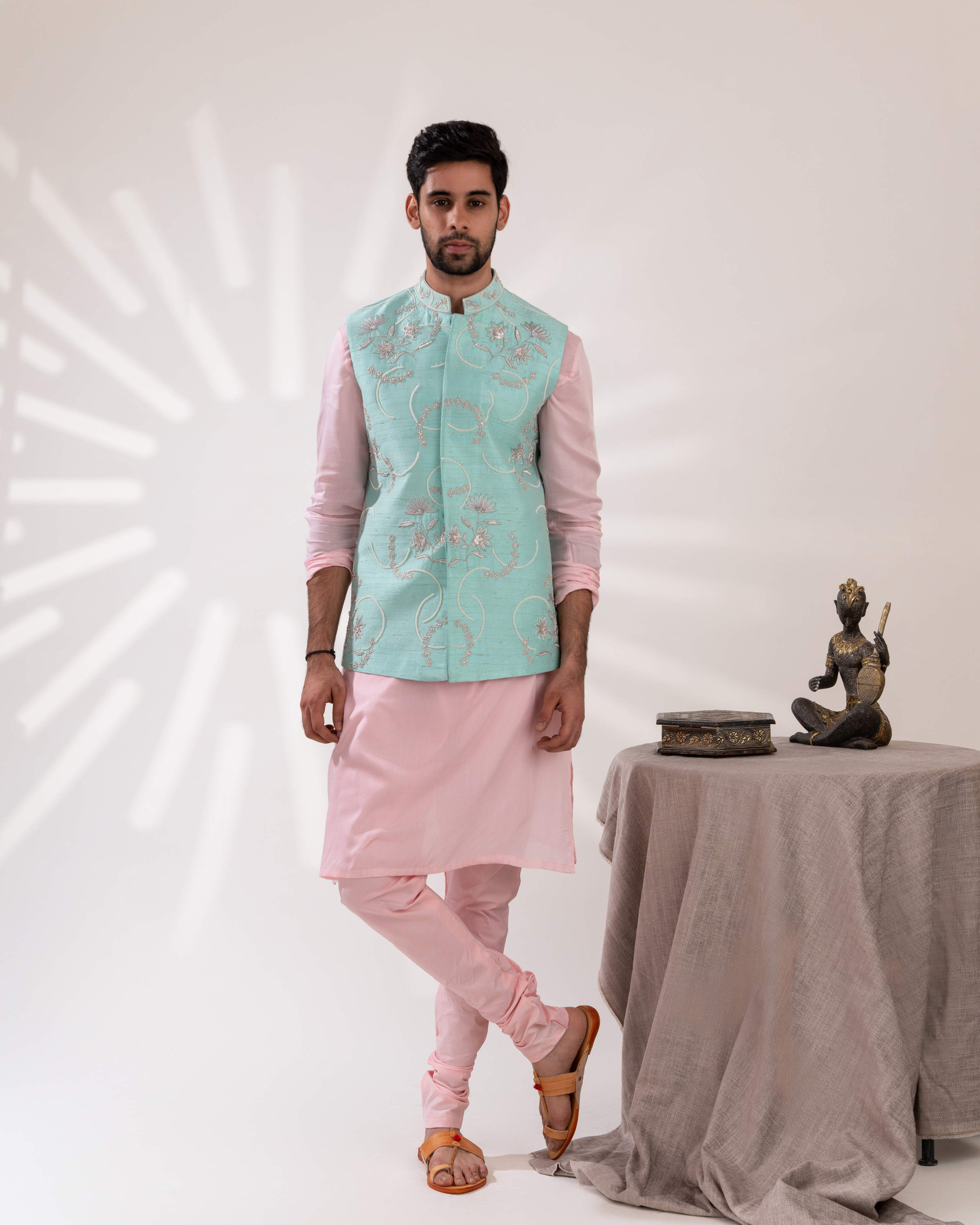 Frontal image capturing the balanced aqua-peach combination of kurta bundi set