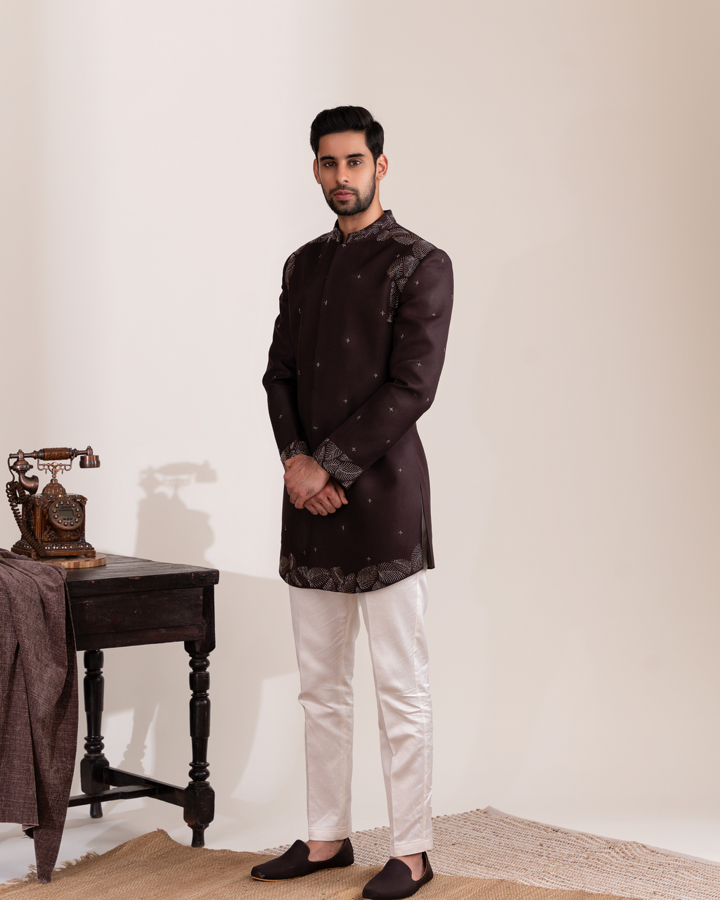 Front view of a warm brown Indo-western bandhgala with foliage motifs.
