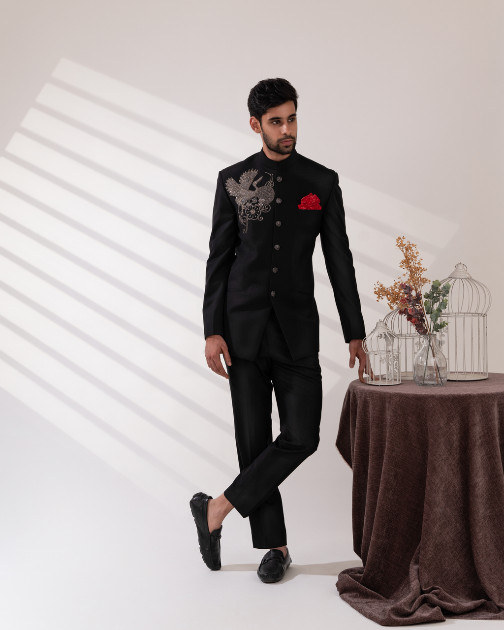 Man in a black suit with a red pocket square