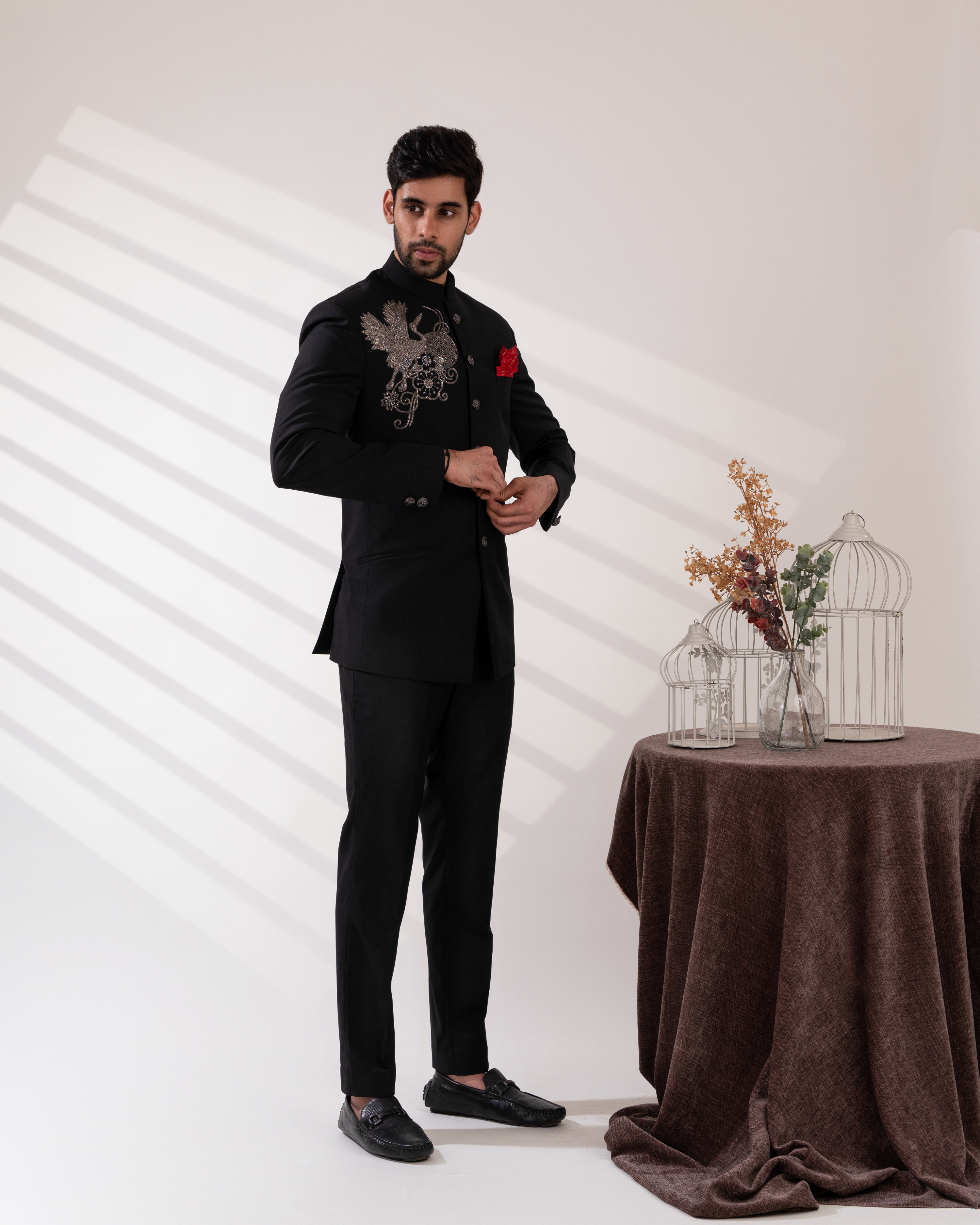 Side view showing bandhgala tailoring and embroidery paired with straight fit pants