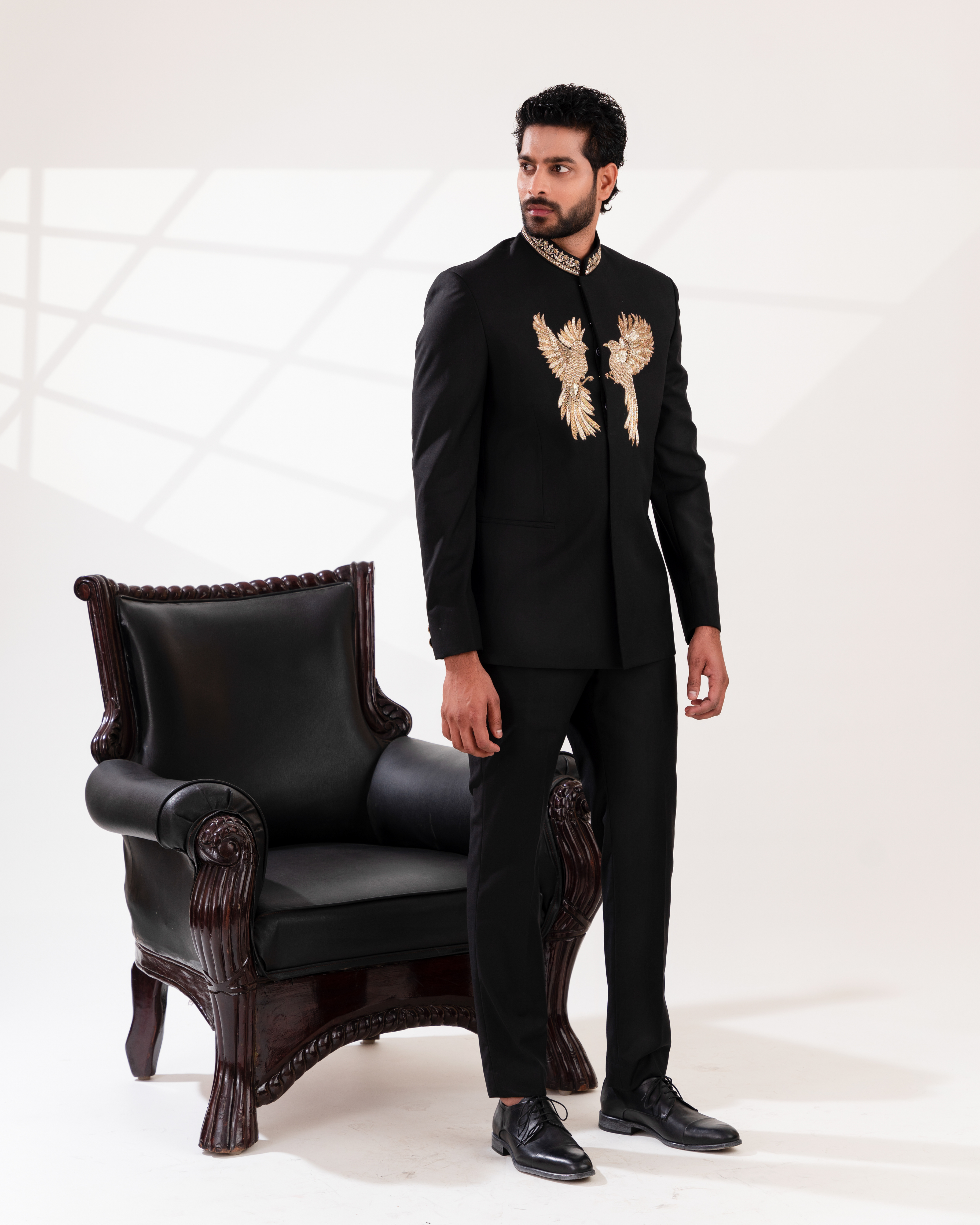 Side profile showing gold embroidery placement on bandhgala paired with straight pants