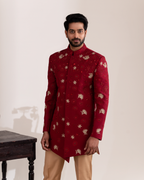 Frontal shot highlighting the rich red bandhgala and floral embroidery