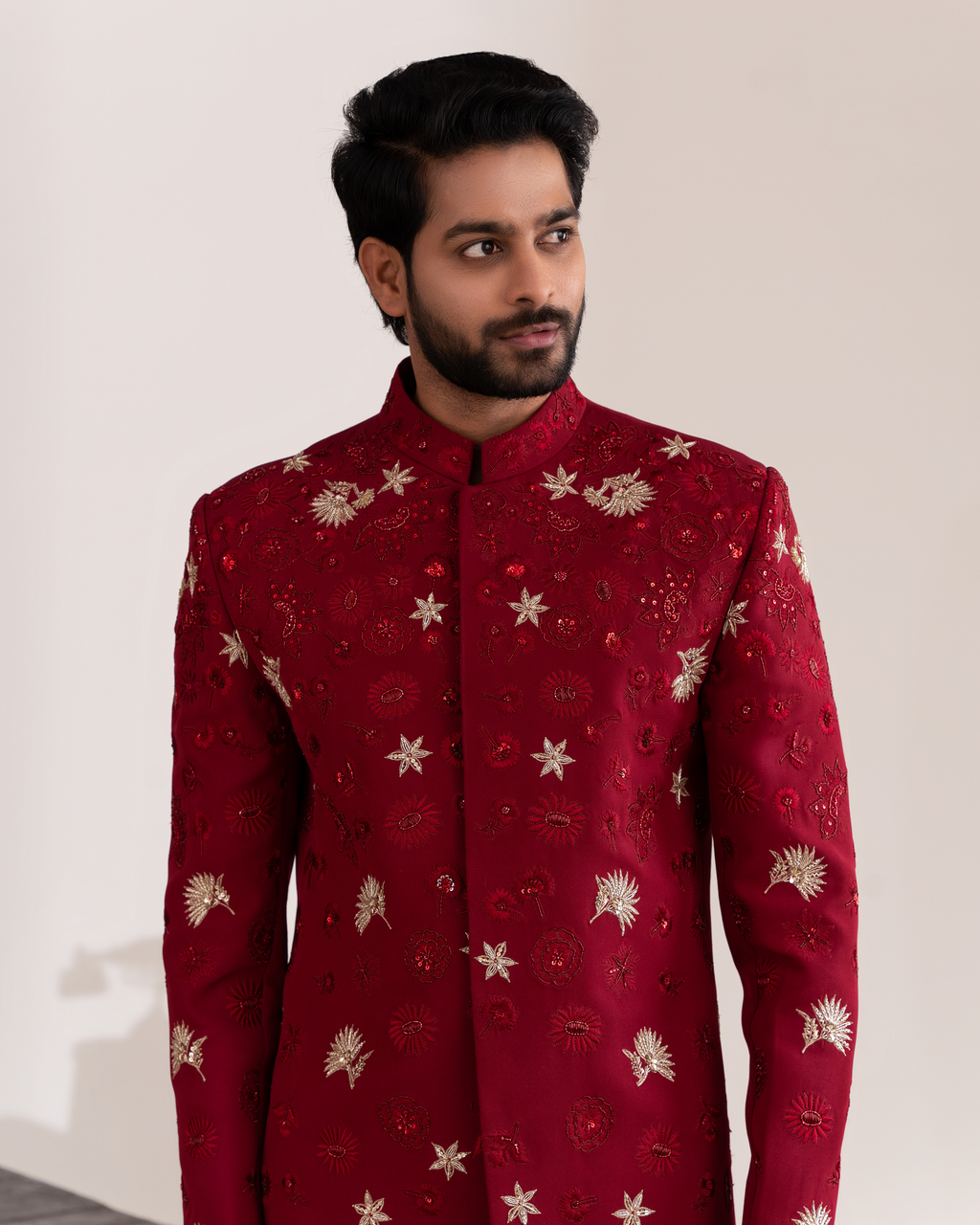 Front angle showcasing detailing on red bandhgala with floral embroidery