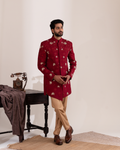 Front view of a Moroccan red Indo-western bandhgala with beige straight pants
