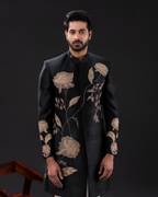 Frontal shot showcasing the gold motifs on the black sherwani