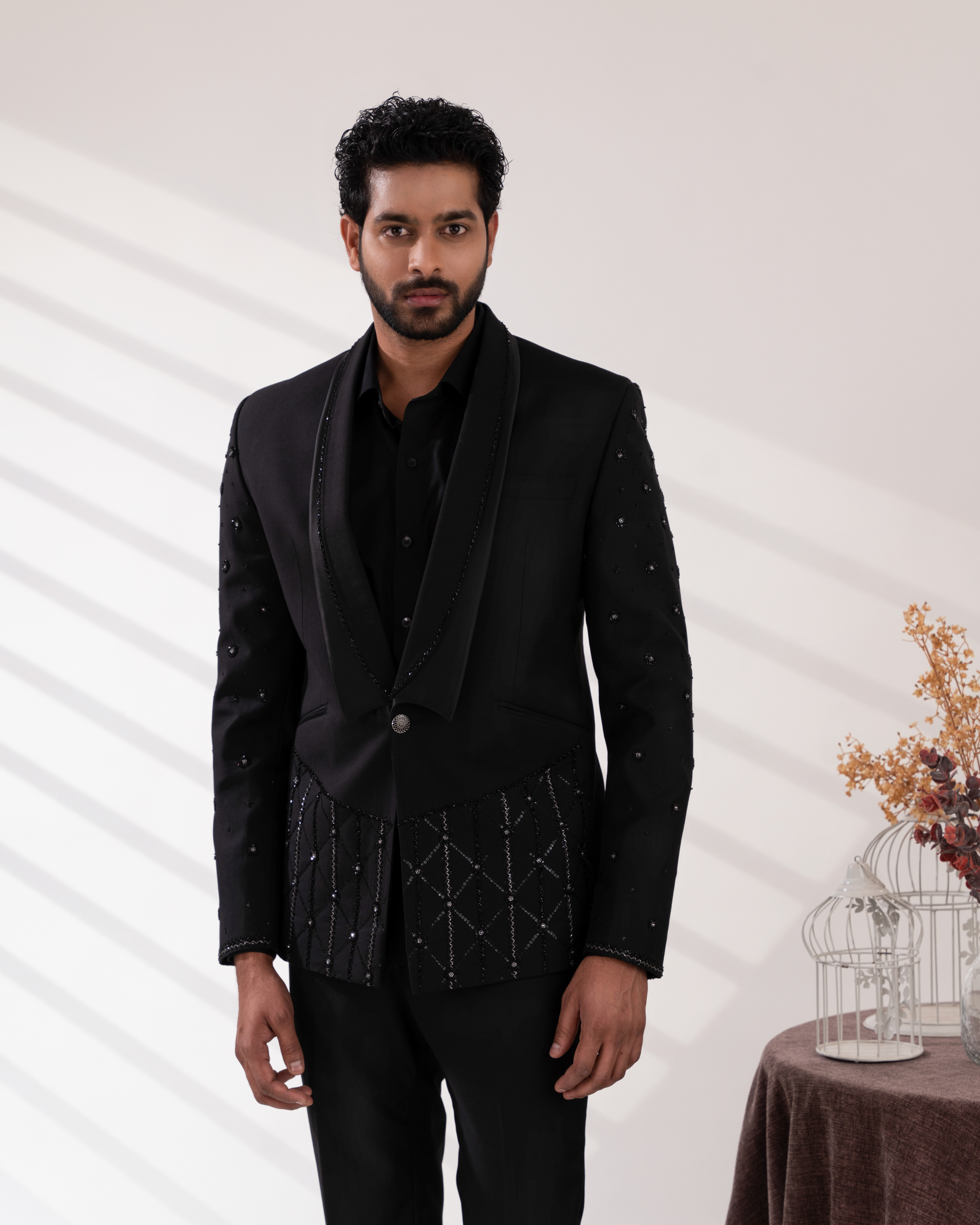Full front view highlighting embroidered black tuxedo