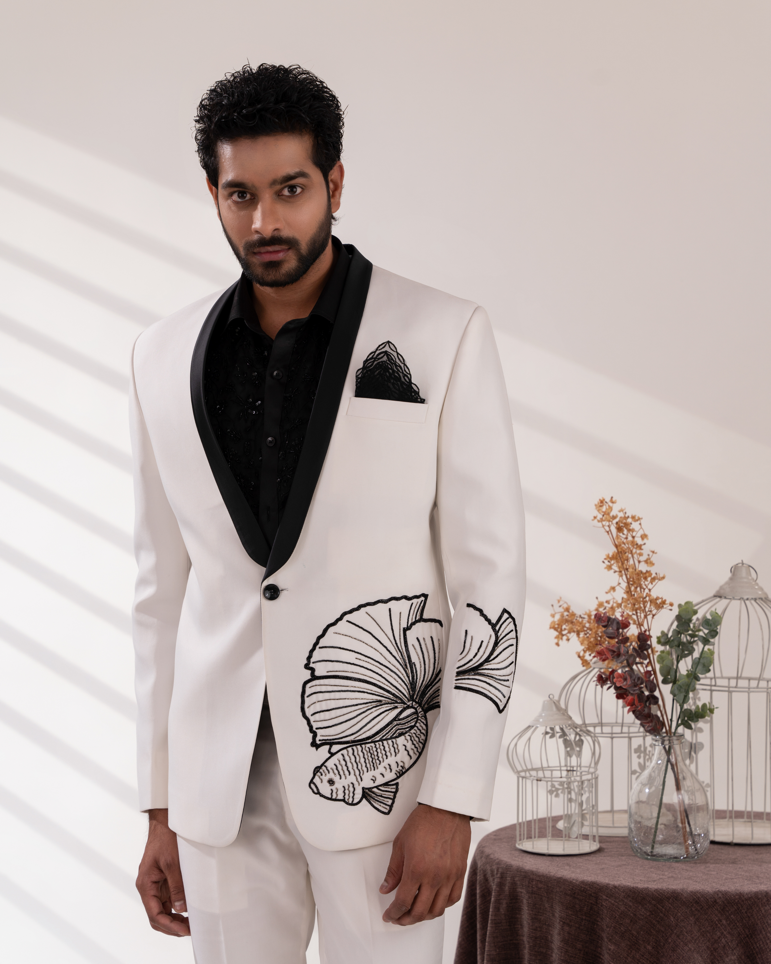 Frontal shot showing white tuxedo and fish motif embroidery