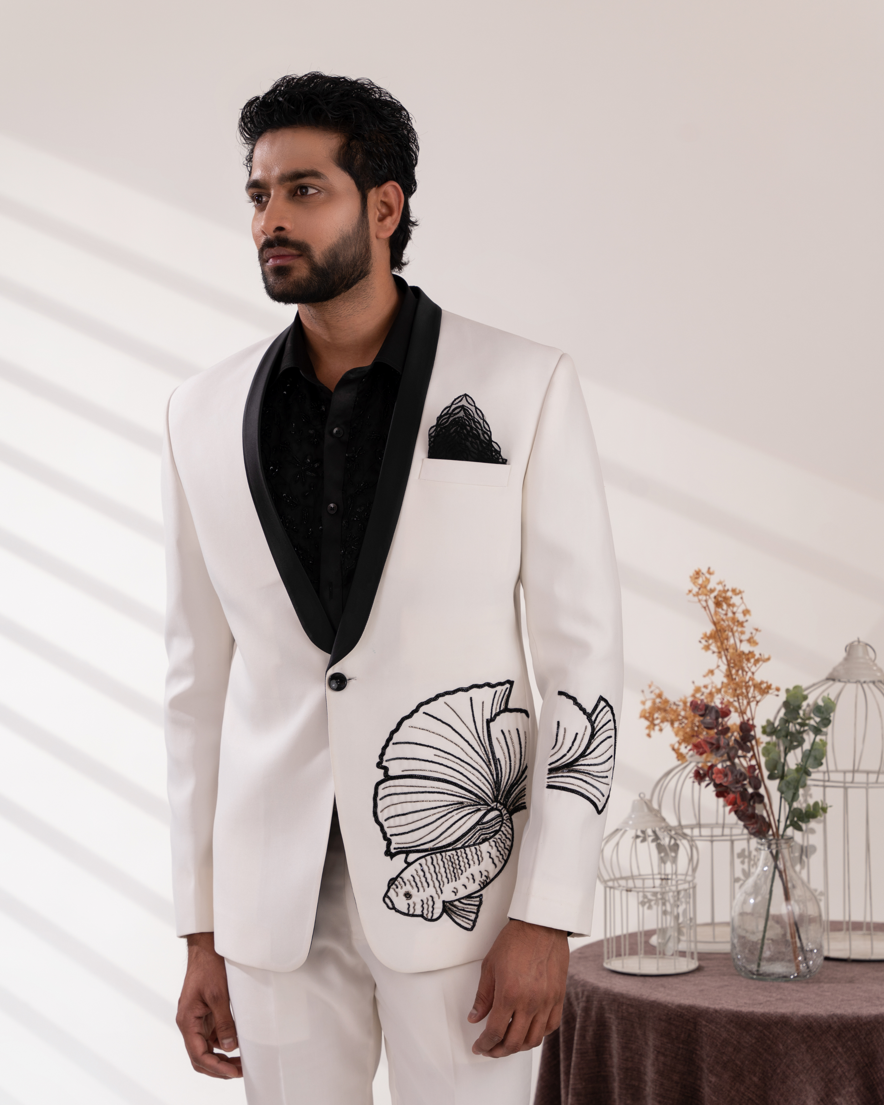 Close up shot showing fish embroidery on white tuxedo