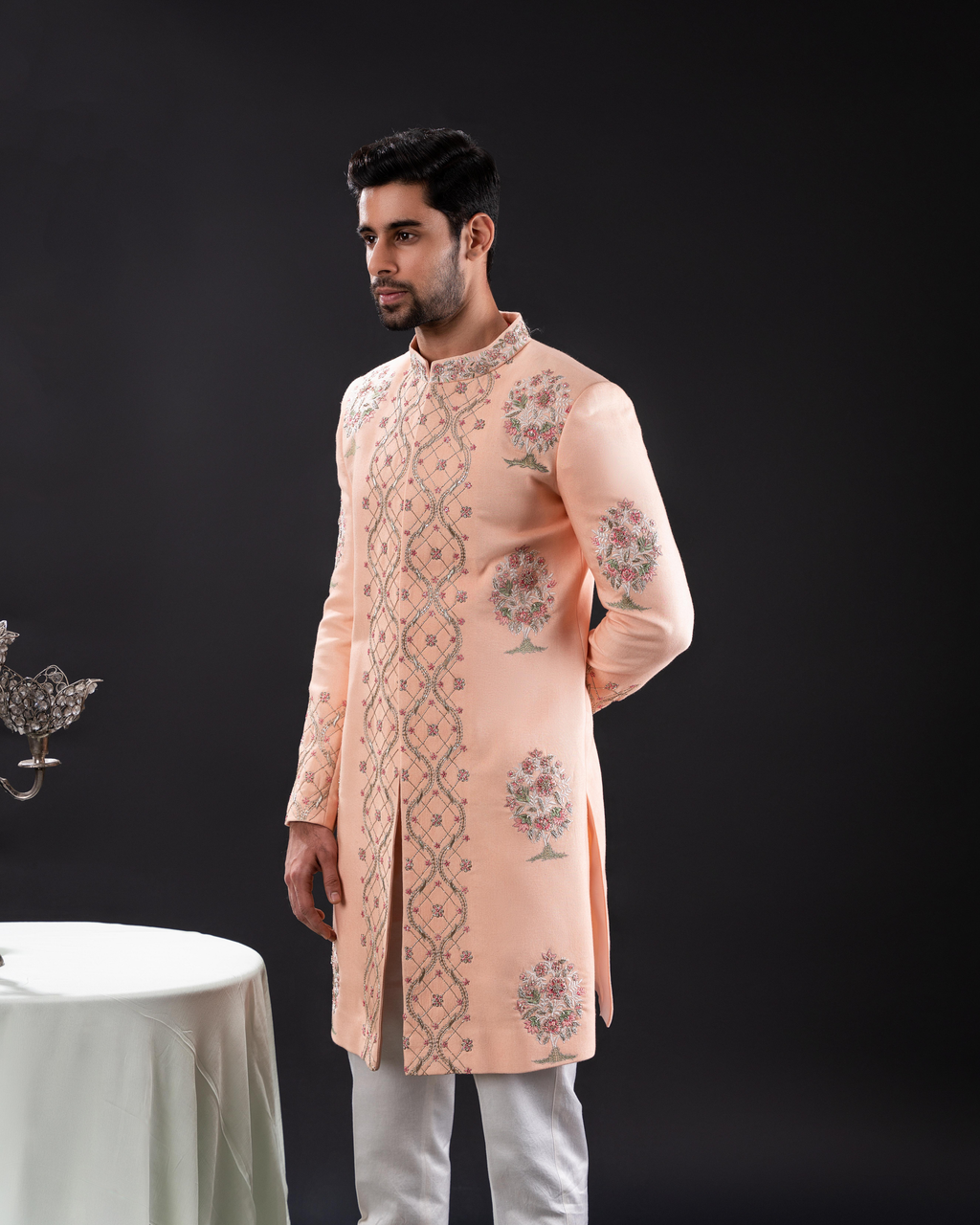 Side profile highlighting the peach-toned sherwani detailing.