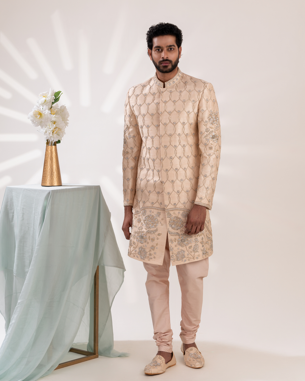 Front angle highlighting embroidery on ivory sherwani with matching pants