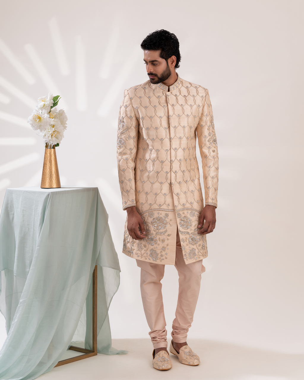 Man wearing a beige embroidered sherwani with matching pant