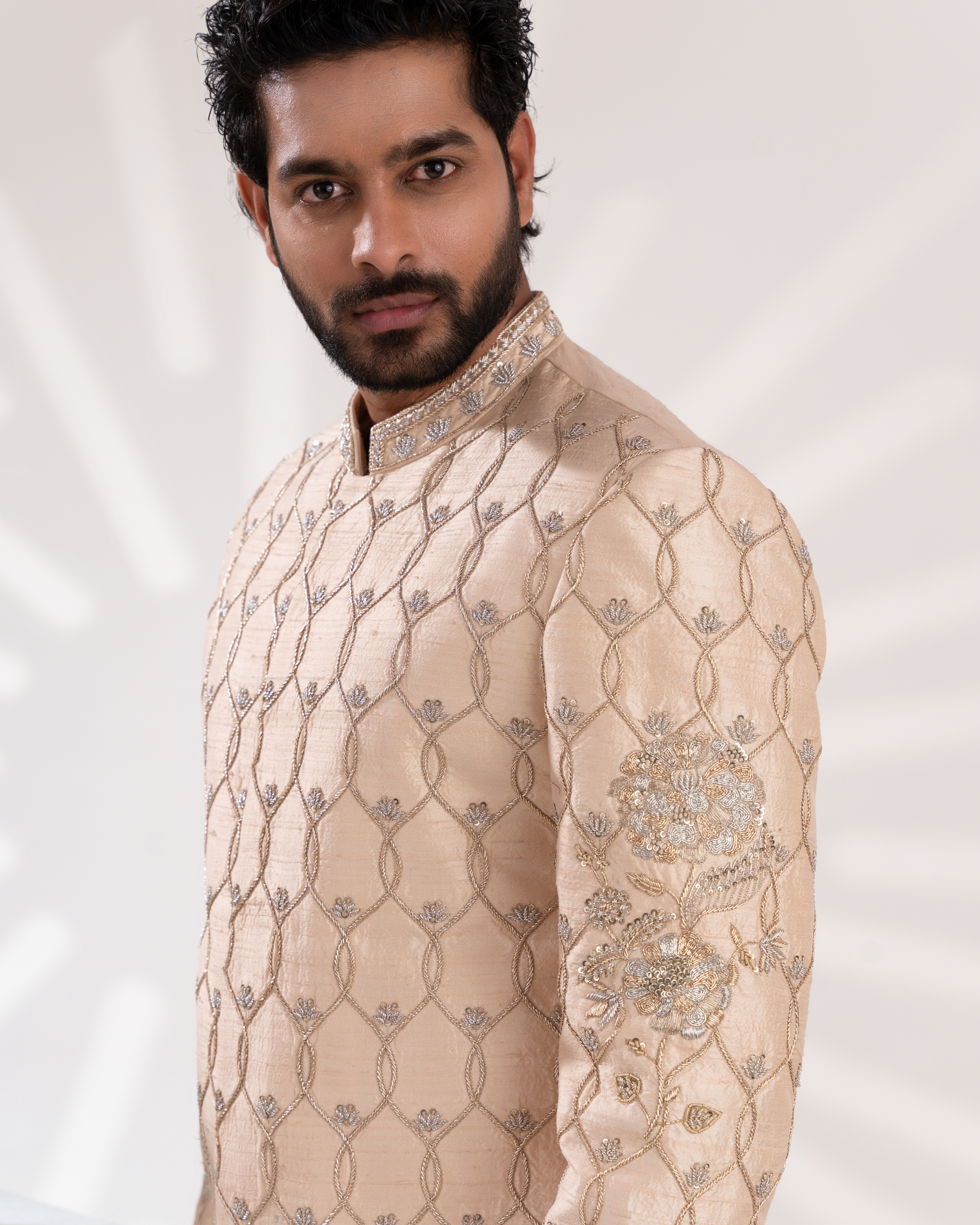 Close-up of ivory sherwani embroidery detailing.