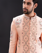 Close-up of floral embroidery on the peach sherwani.