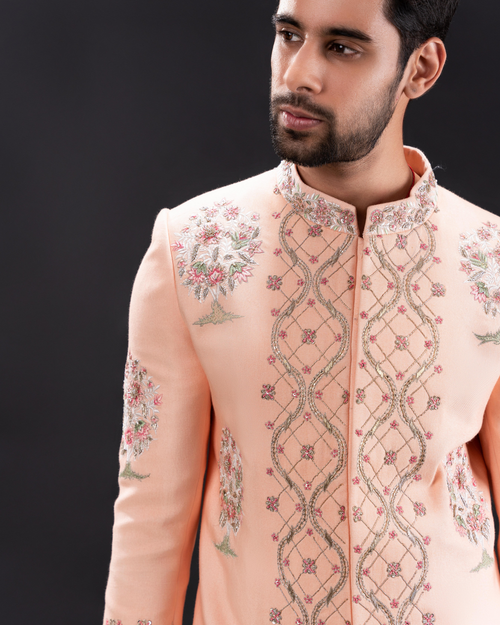 Close-up of floral embroidery on the peach sherwani.
