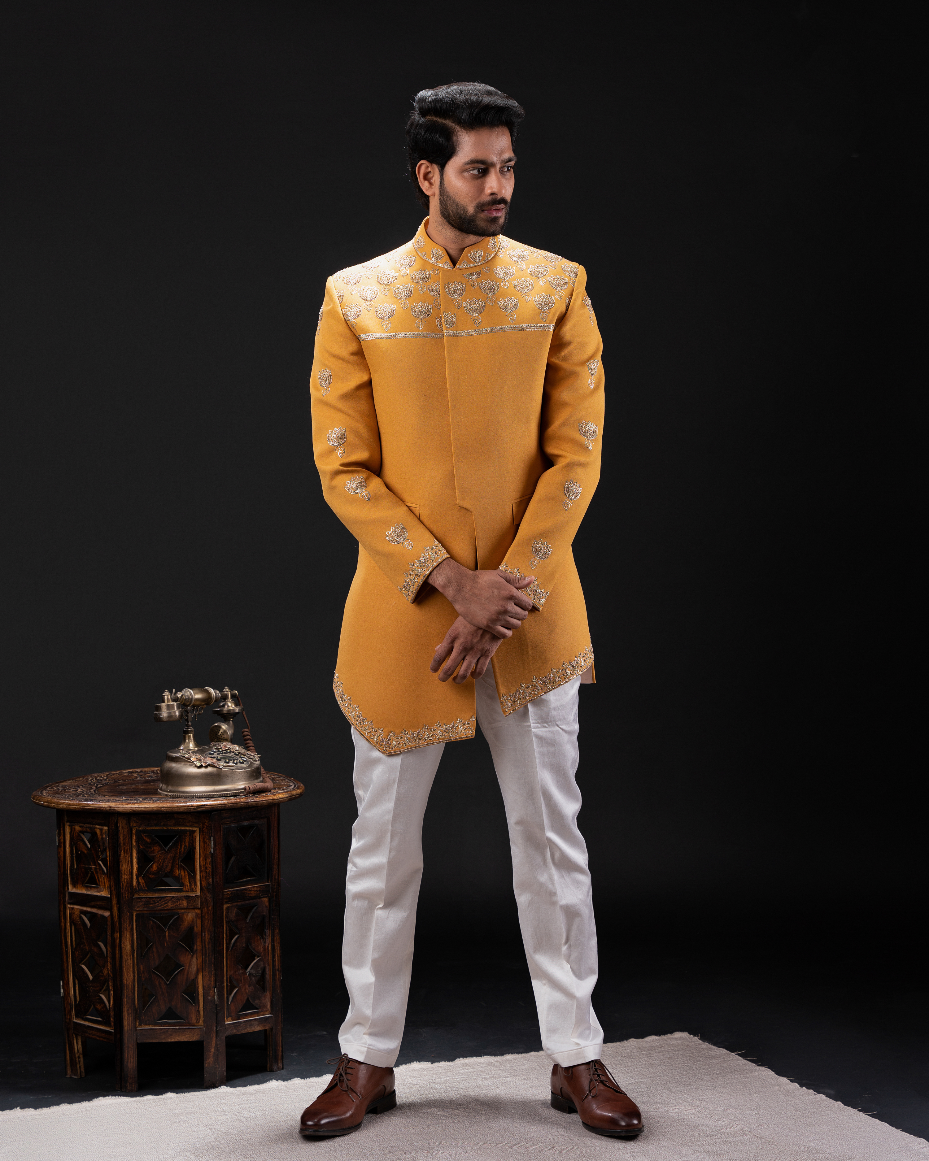 Front view of a mustard Indo-western bandhgala with pitta work.