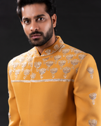Close up shot of mustard yellow embroidered bandhgala 