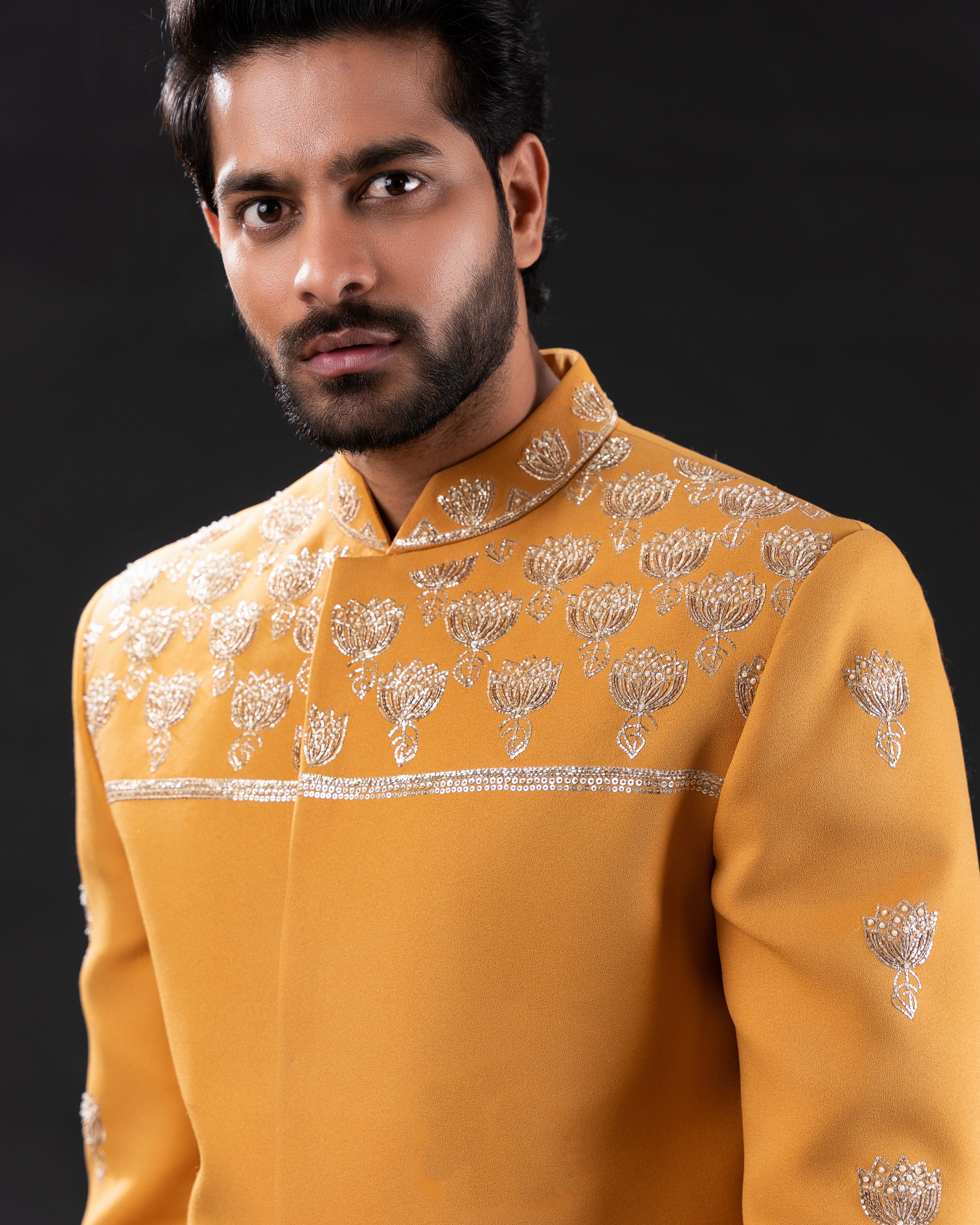Close up shot of mustard yellow embroidered bandhgala 