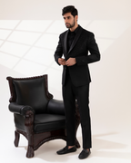 Front view of a black shawl-collar tuxedo shirt and pant set.