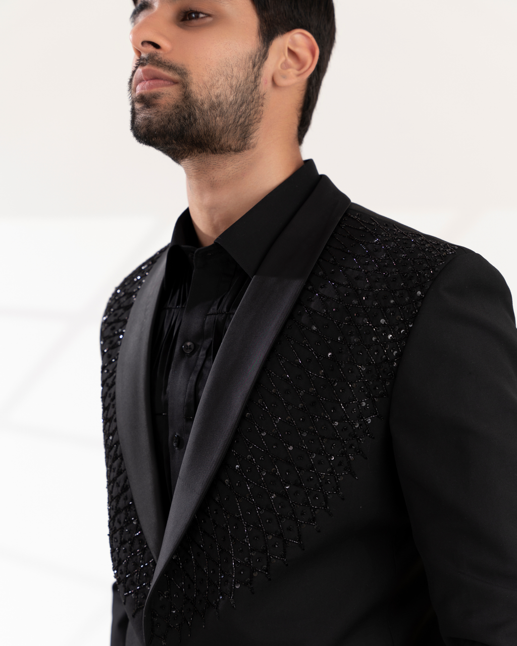 Close-up of collar detailing and tuxedo surface texture.