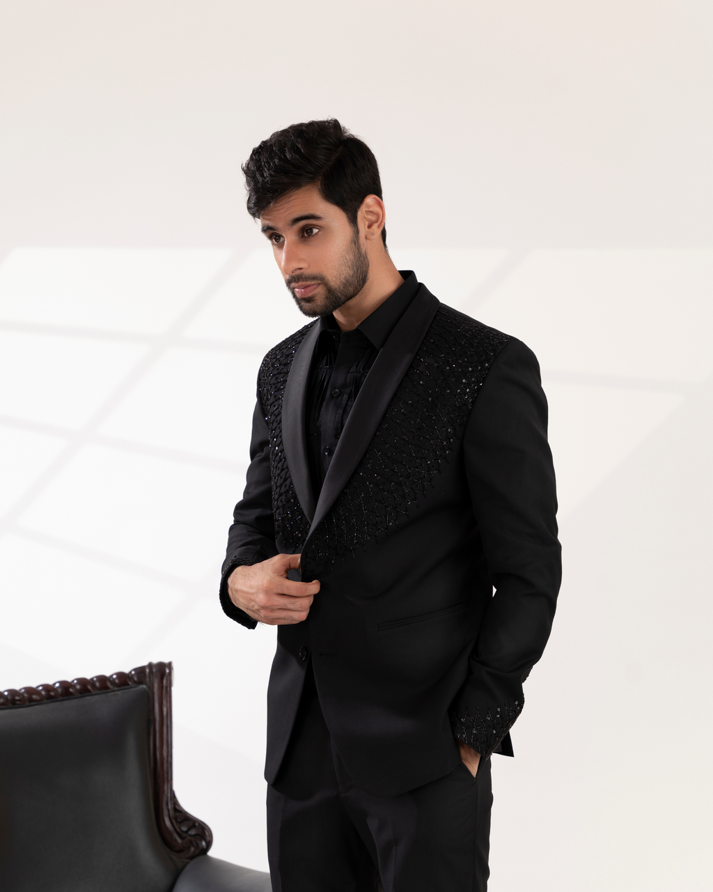 Side profile showing tuxedo line and embroidery detailing.