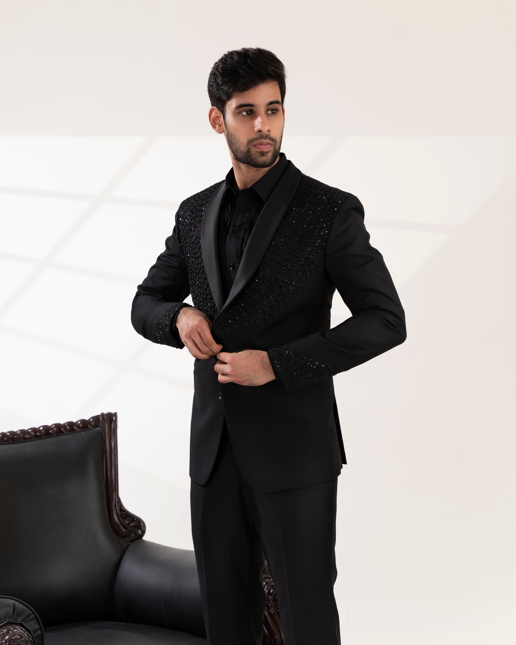 Frontal shot showcasing the sleek collar and structured tuxedo fit.