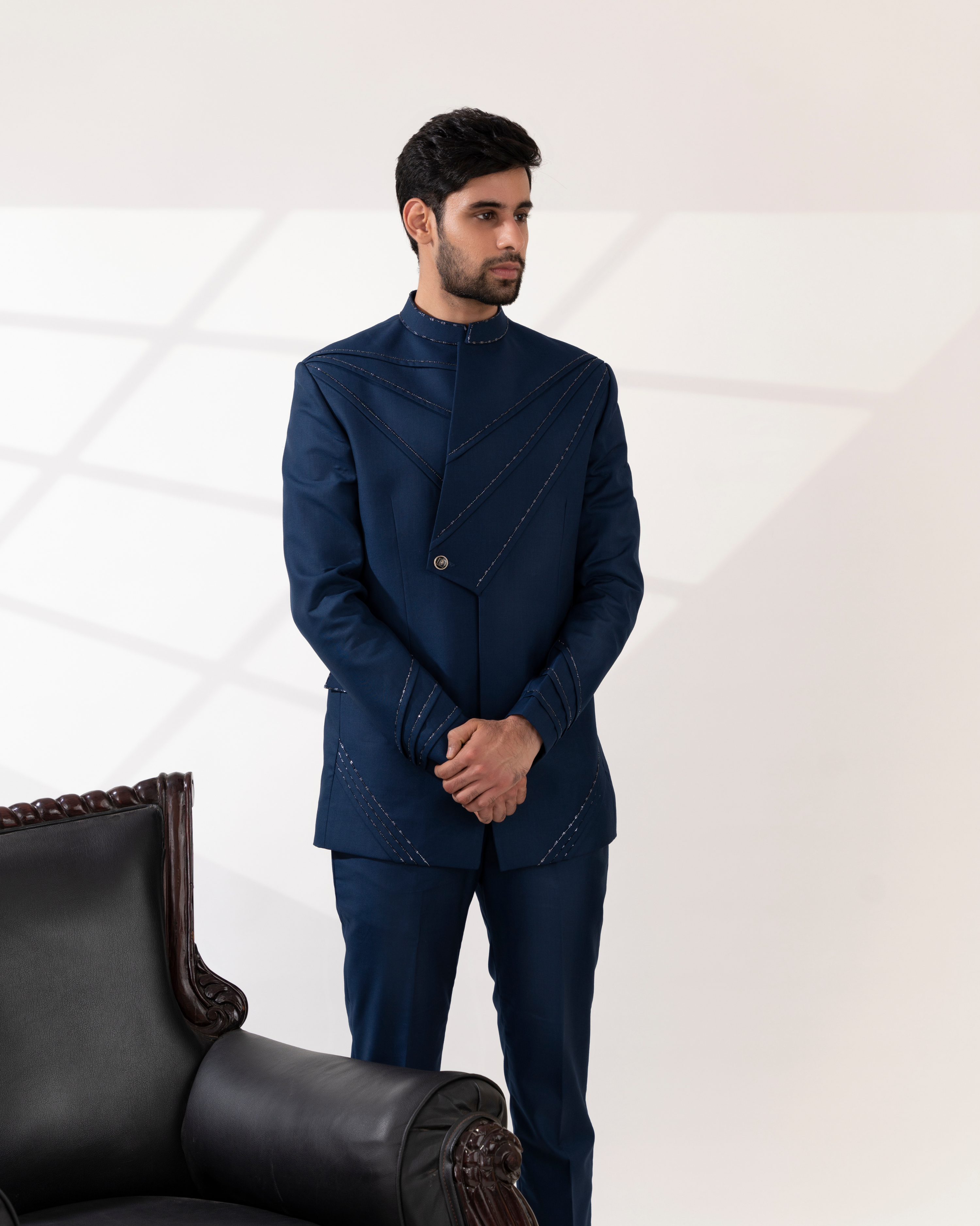 Front view of a navy blue bandhgala suit with pintucks detailing