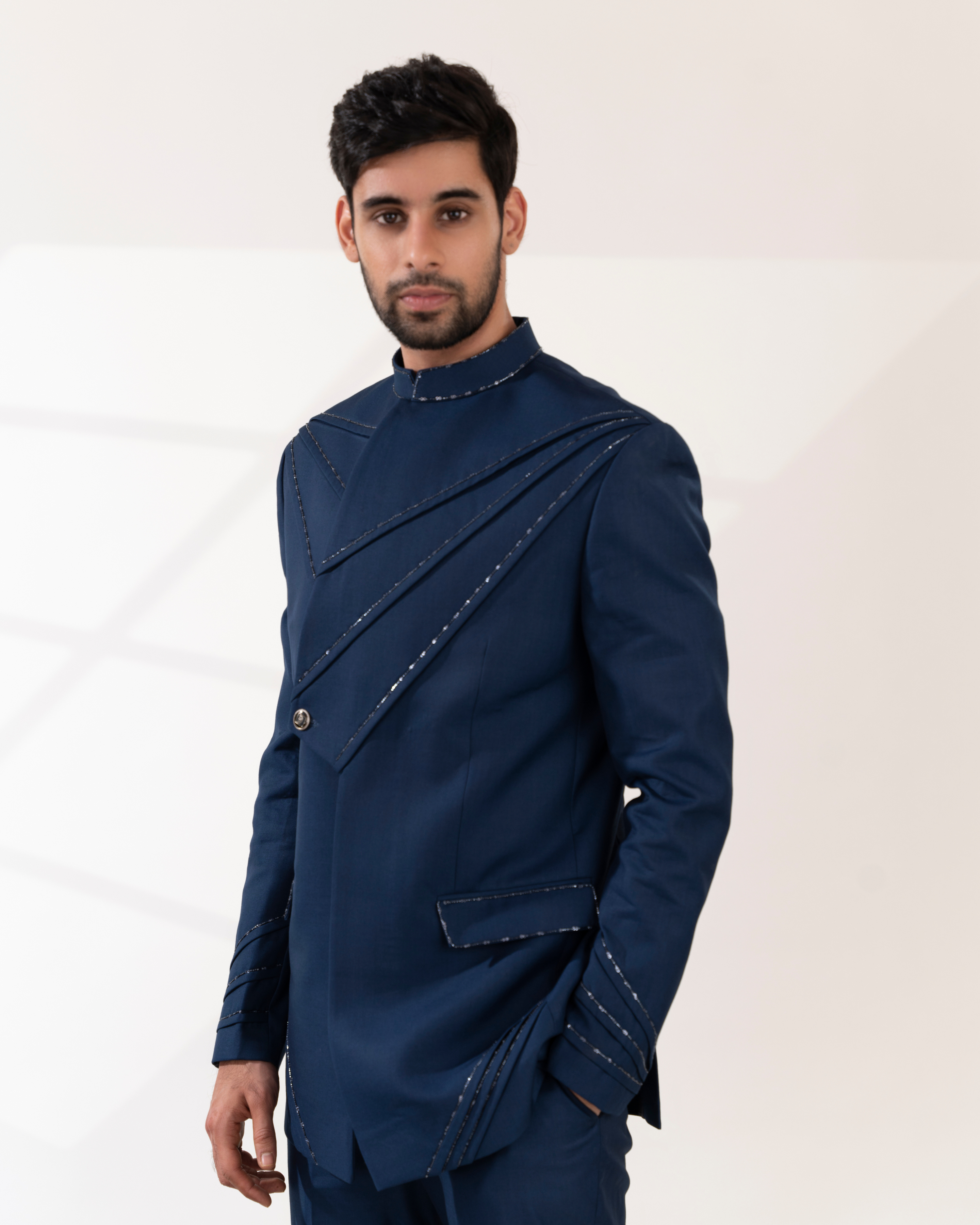 Side profile showing navy blue bandhgala structure and tailored lines.