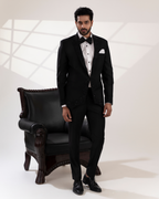 Full front view of embroidered black blazer and pant suit