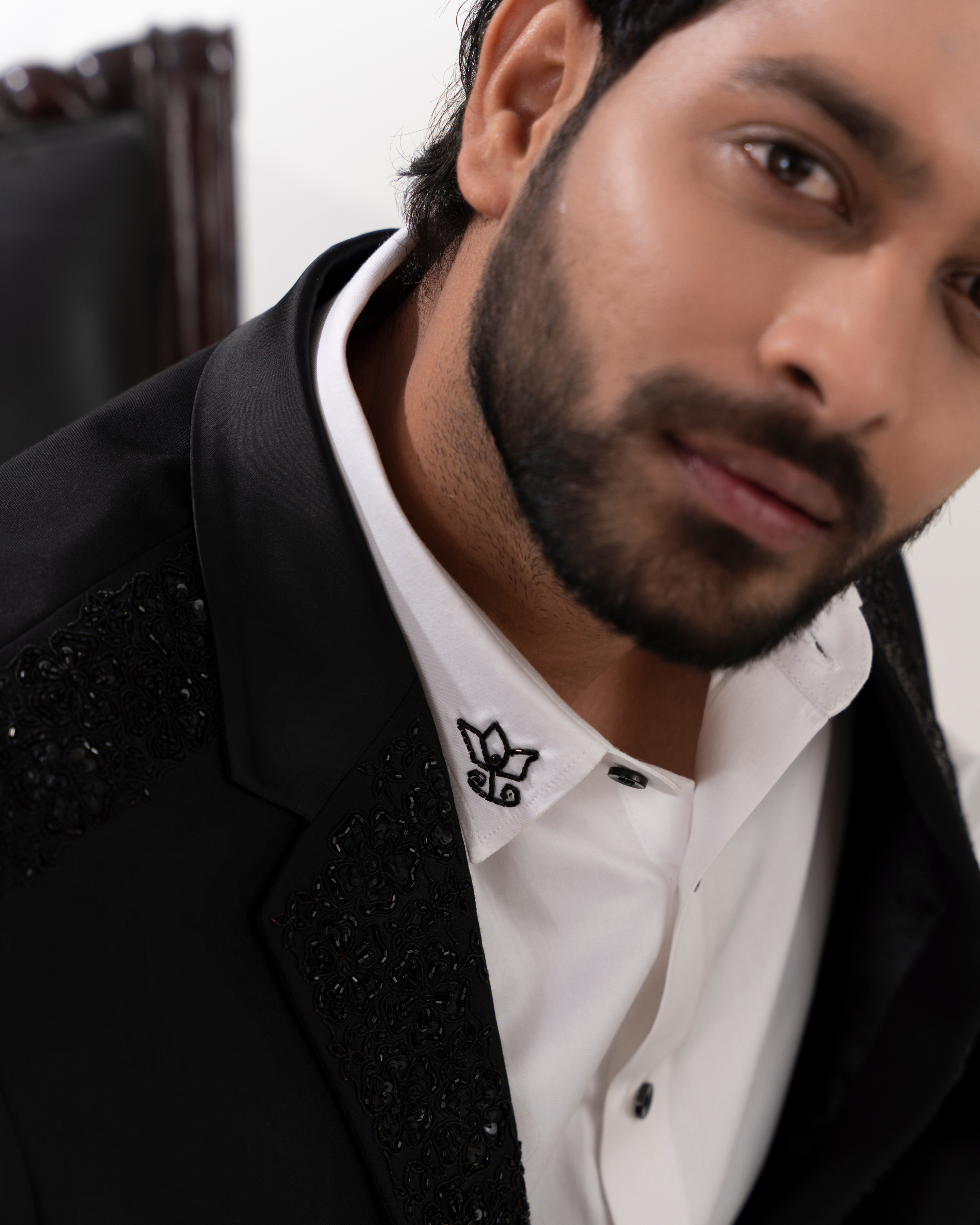 Close-up of embroidery on the blazer and motif on shirt
