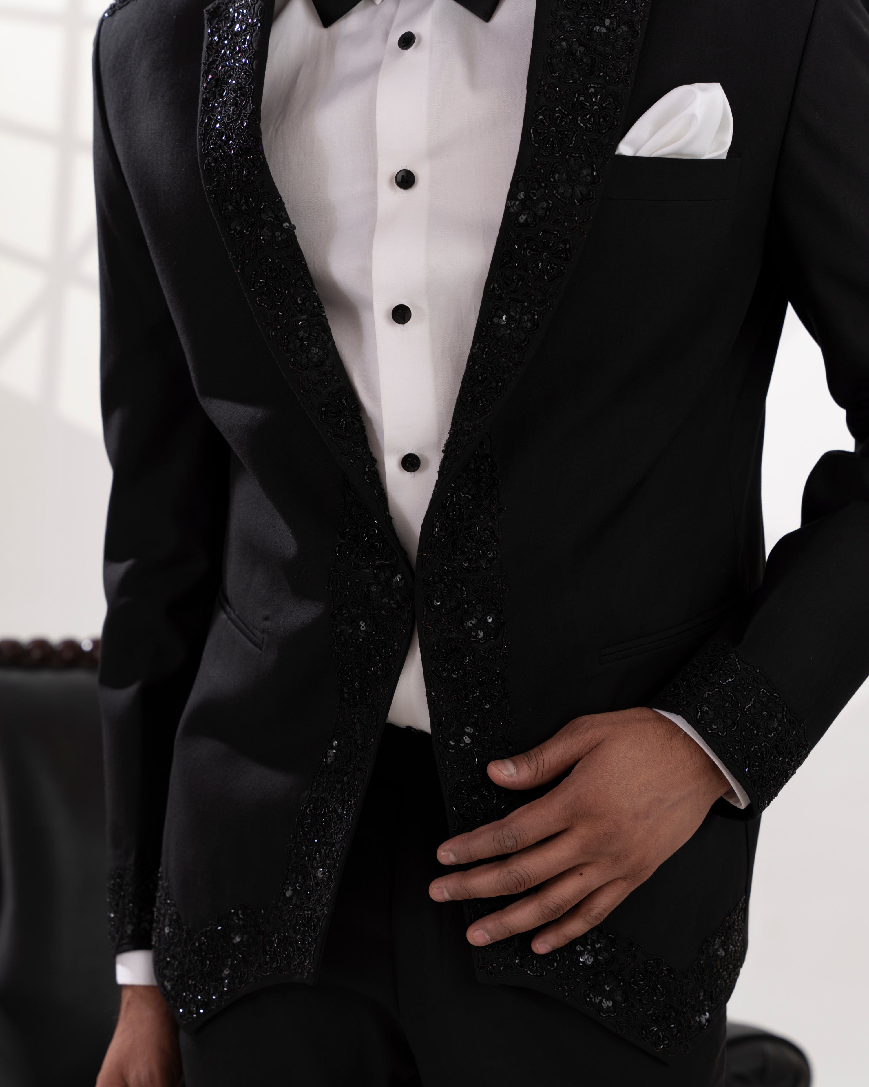 Black embroidered tuxedo with white shirt and bow tie 