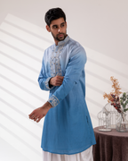 Side view showing the ombré kurta and fine embroidery.