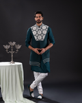 Front view of a jewel-toned green Bundi set with a rich finish.
