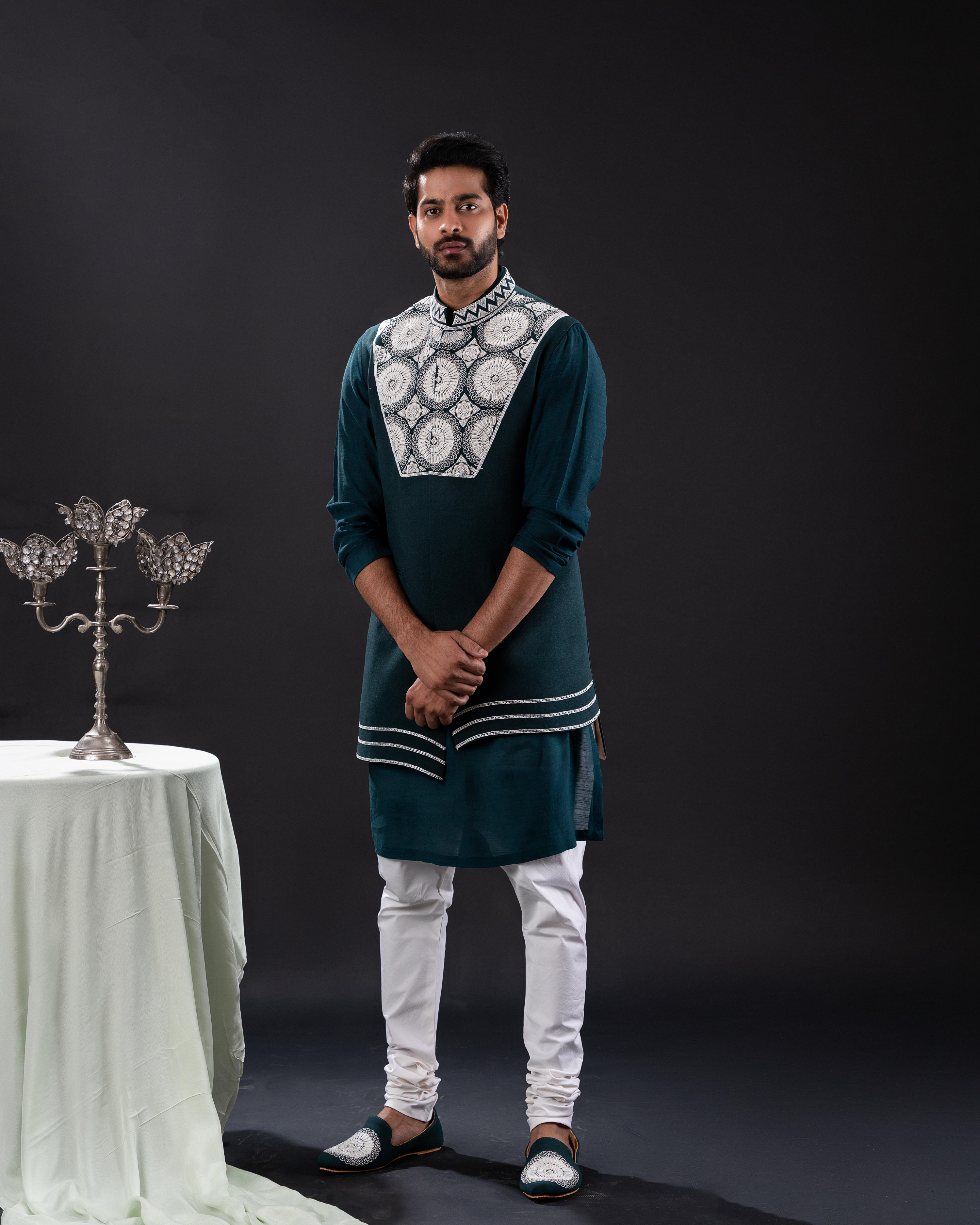 Dark green kurta and bundi with white embroidery paired with white pants