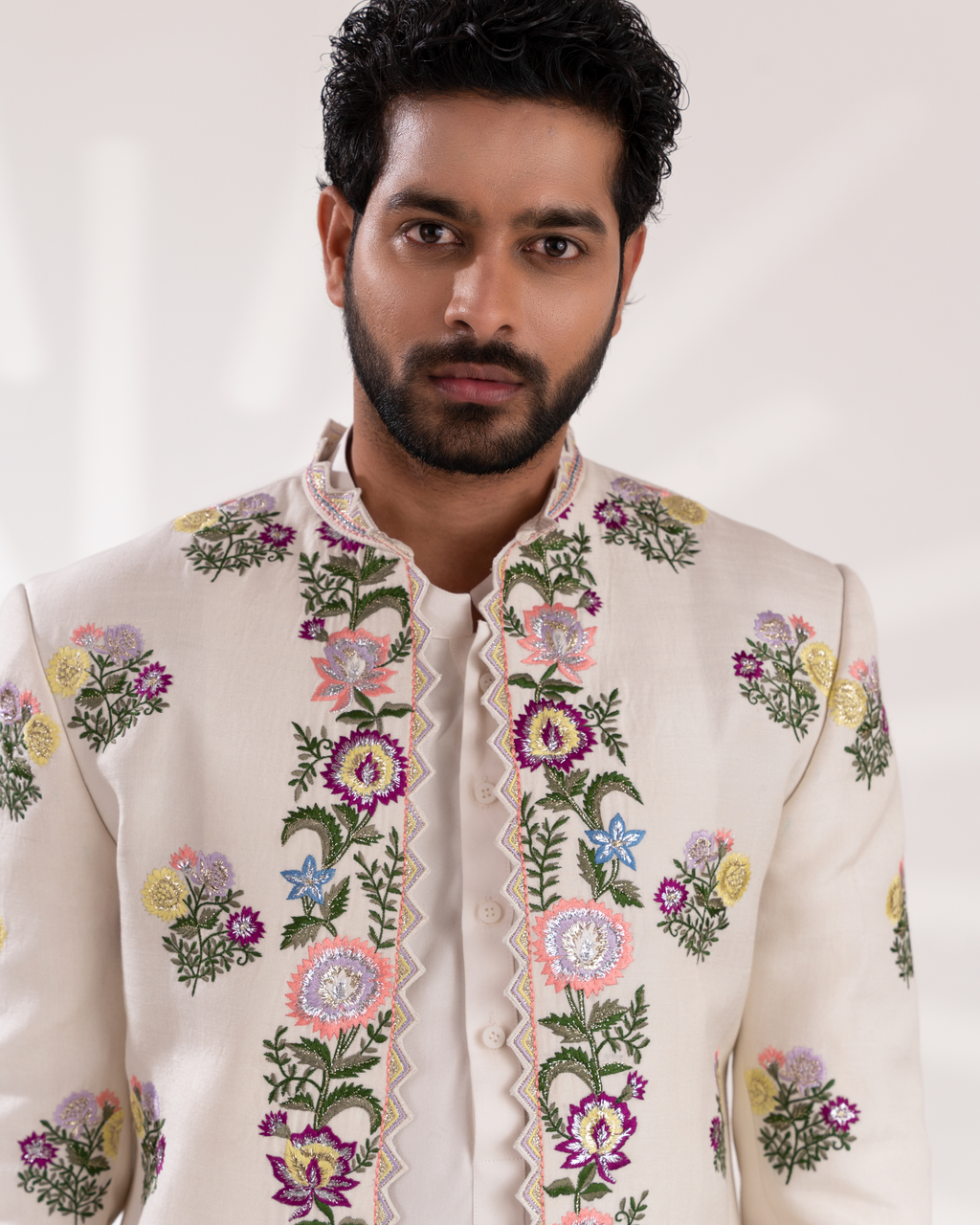 Detailed embroidery shot showing threadwork on white sherwani