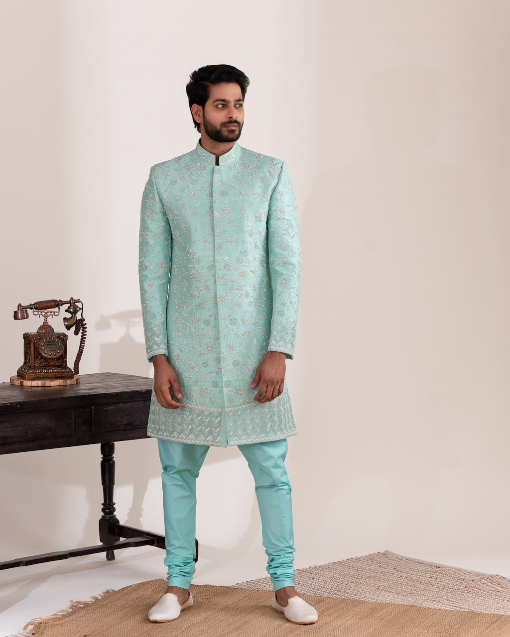 Front view of light blue sherwani with matching chudi pants