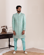 Front view of light blue sherwani with matching chudi pants