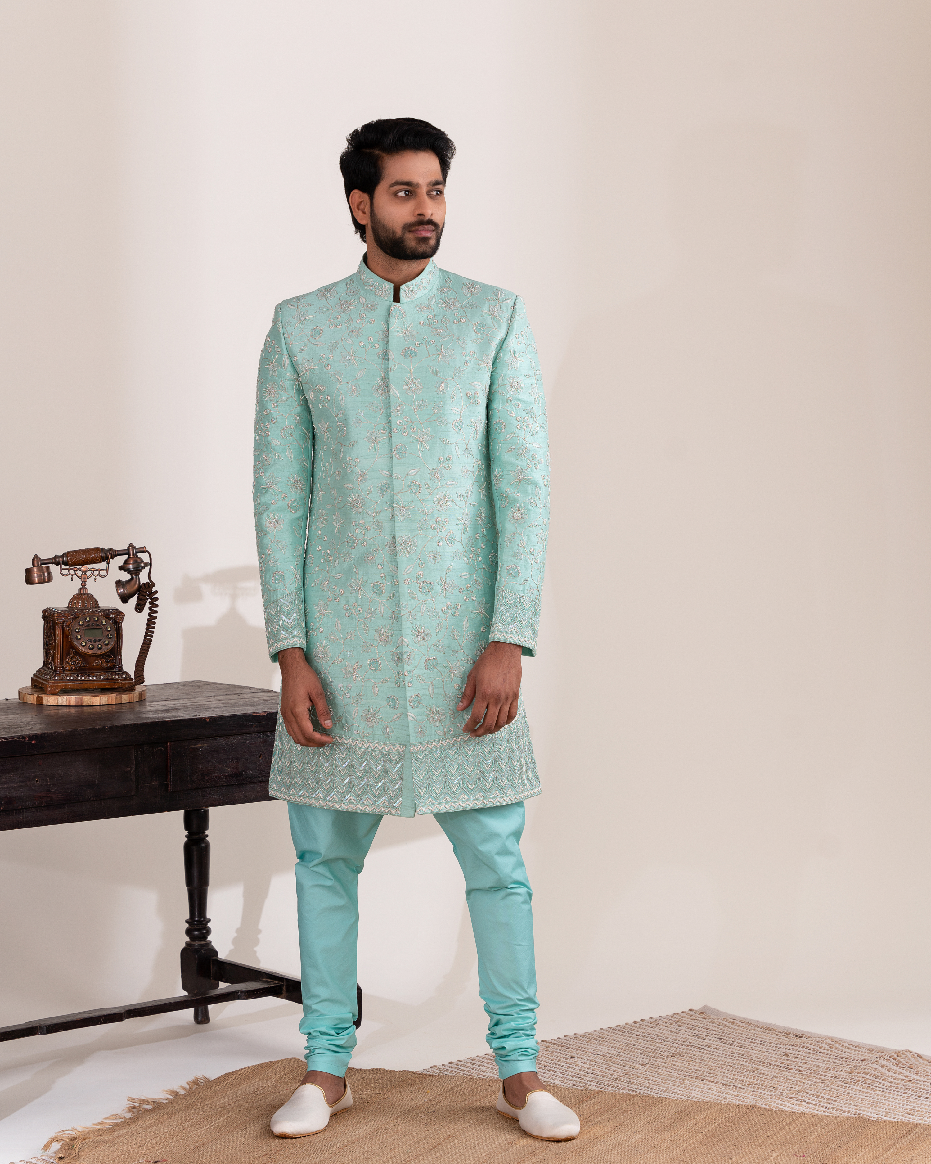 Front view of light blue sherwani with matching chudi pants