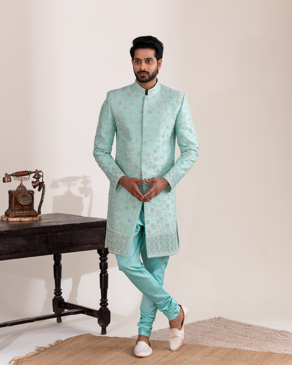 Front view of a serene aqua sherwani paired with chudi pants.
