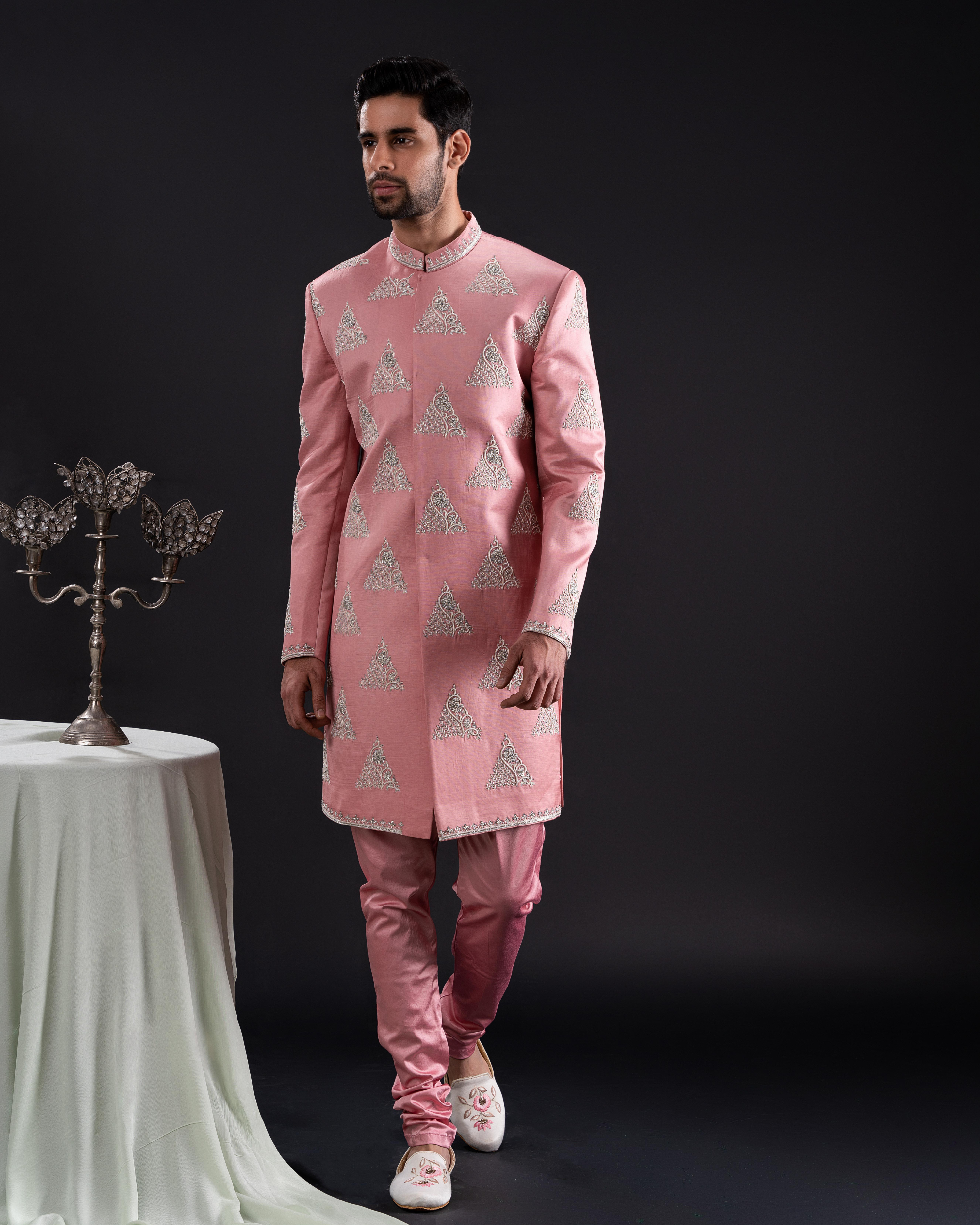 Frontal shot showcasing the soft salmon sherwani and matching chudi pants
