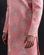 Detailed shot showing silver embroidery on salmon sherwani