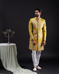 Front view of a gold-embroidered sherwani with chudi pants.